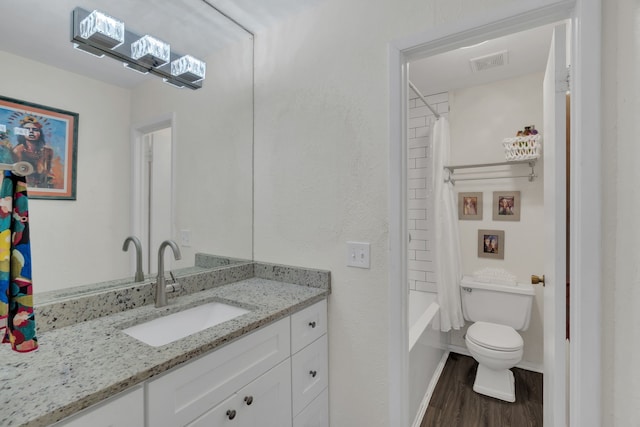 bathroom with vanity, wood finished floors, visible vents, shower / bath combo, and toilet