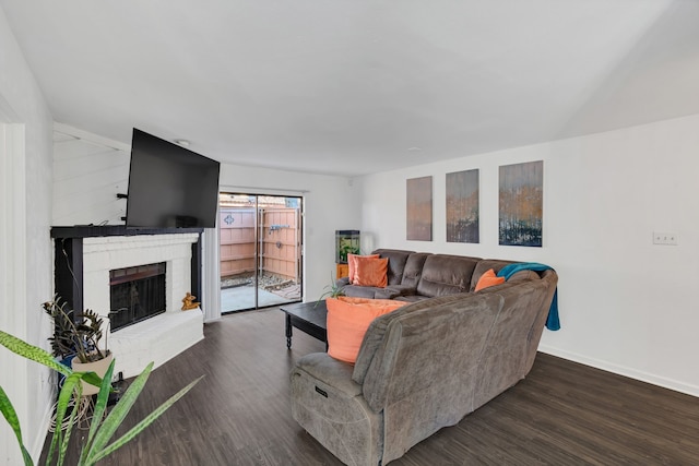 living area with a fireplace, wood finished floors, and baseboards