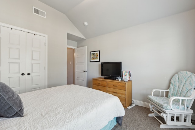 bedroom with lofted ceiling, a closet, visible vents, and carpet