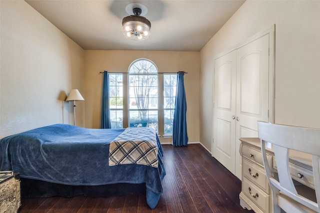 bedroom featuring dark wood-type flooring and baseboards