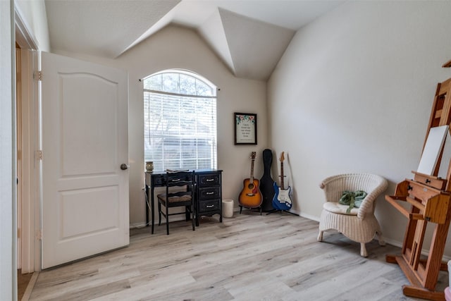 sitting room with lofted ceiling, wood finished floors, and baseboards