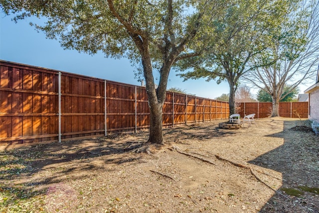 view of yard featuring an outdoor fire pit and a fenced backyard