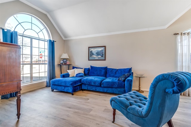 living area featuring lofted ceiling, baseboards, wood finished floors, and crown molding