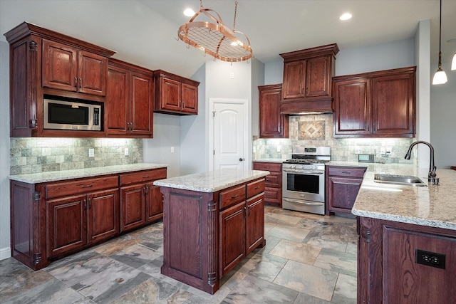 510 Meadow Pond Ct, Runaway Bay, TX 76426 - kitchen with a sink, hanging light fixtures, light stone countertops, and stainless steel appliances