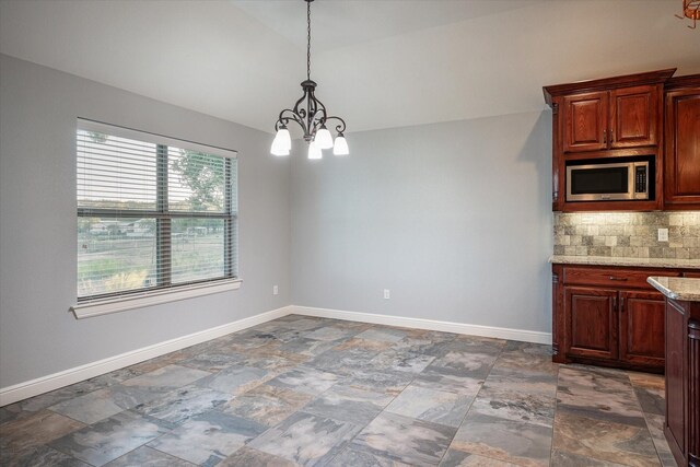 510 Meadow Pond Ct, Runaway Bay, TX 76426 - unfurnished dining area with baseboards, lofted ceiling, an inviting chandelier, and stone finish floor