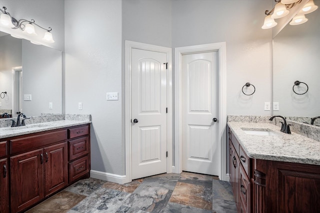 510 Meadow Pond Ct, Runaway Bay, TX 76426 - full bath featuring stone finish floor, two vanities, baseboards, and a sink