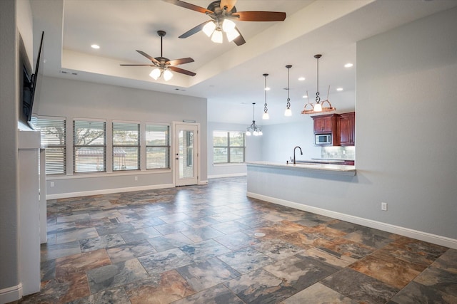 510 Meadow Pond Ct, Runaway Bay, TX 76426 - unfurnished living room with a tray ceiling, recessed lighting, a ceiling fan, and baseboards