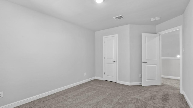 unfurnished bedroom with carpet floors, visible vents, and baseboards