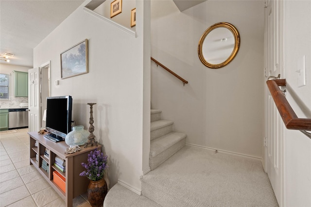 stairs with baseboards and tile patterned floors