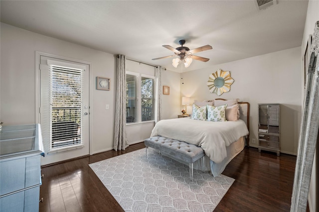 bedroom featuring visible vents, dark wood finished floors, baseboards, ceiling fan, and access to outside