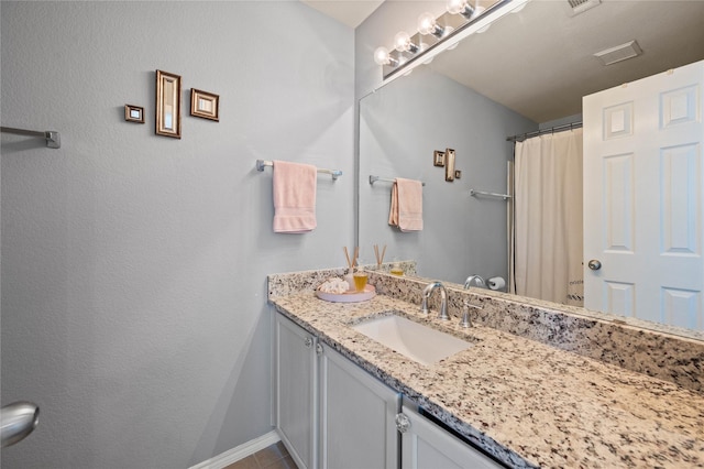 bathroom featuring visible vents, vanity, and a shower with shower curtain