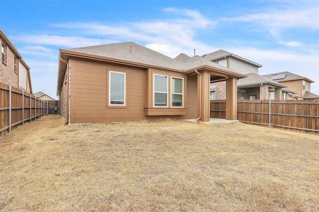 rear view of property with central AC, roof with shingles, and a fenced backyard