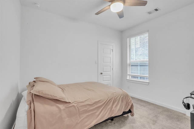 bedroom with a ceiling fan, baseboards, visible vents, and carpet flooring