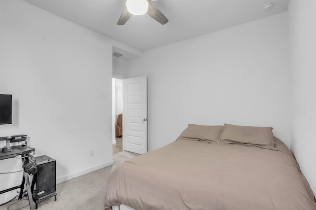 carpeted bedroom featuring a ceiling fan, visible vents, and baseboards