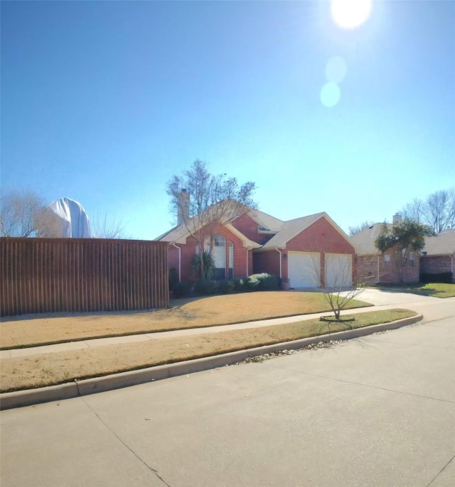 ranch-style house with driveway and an attached garage