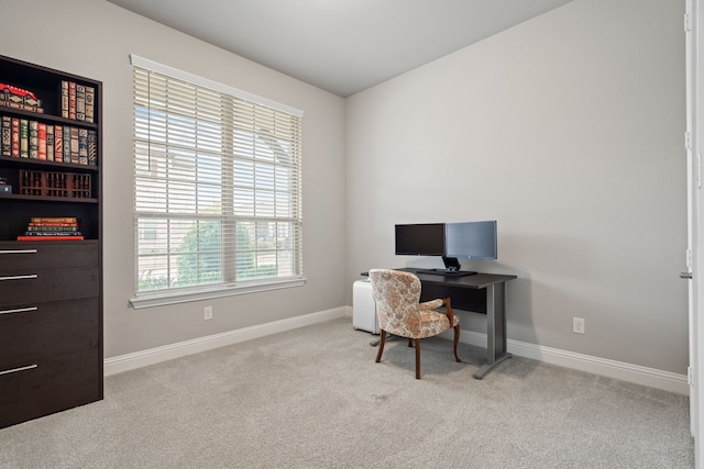 carpeted office featuring baseboards