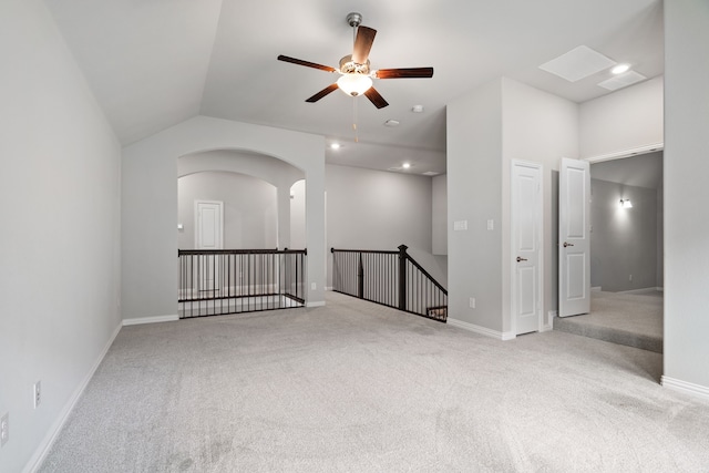 carpeted empty room with a ceiling fan, recessed lighting, vaulted ceiling, and baseboards