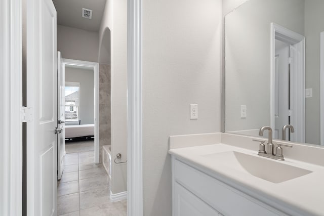 bathroom featuring a bathtub, visible vents, vanity, and tile patterned floors