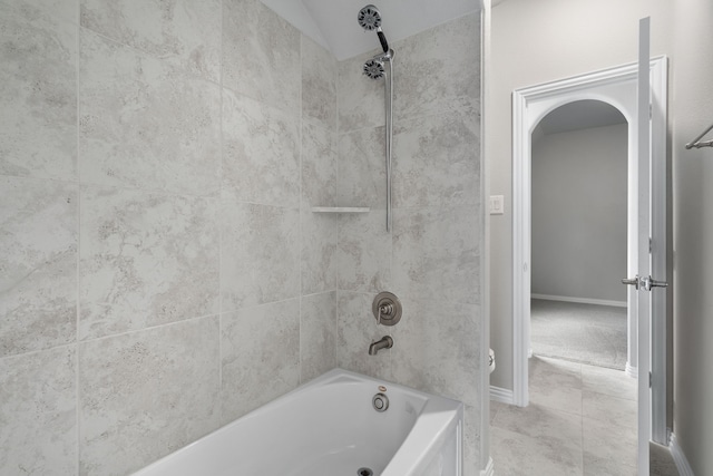 bathroom with bathtub / shower combination and baseboards