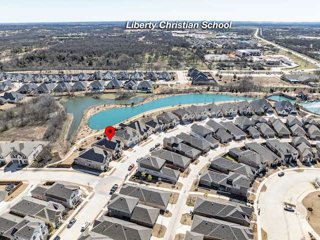 drone / aerial view featuring a water view and a residential view