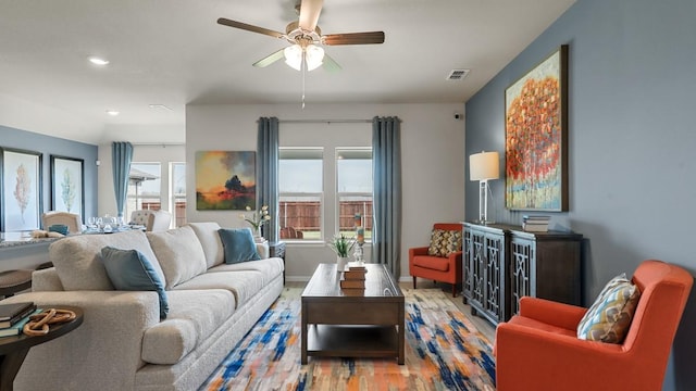 living room with recessed lighting, visible vents, ceiling fan, wood finished floors, and baseboards