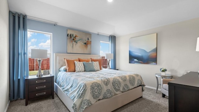 carpeted bedroom featuring baseboards