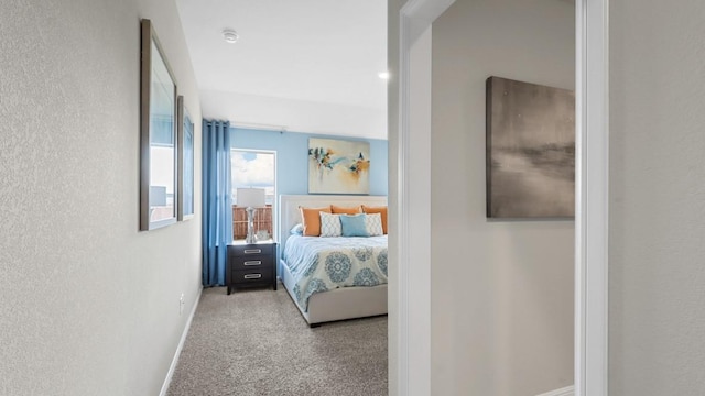 carpeted bedroom featuring baseboards