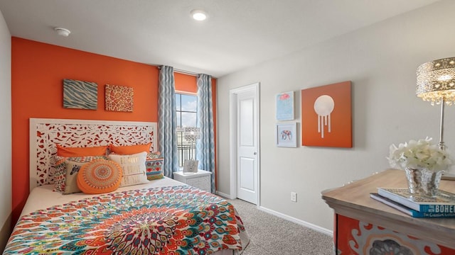 bedroom featuring carpet and baseboards