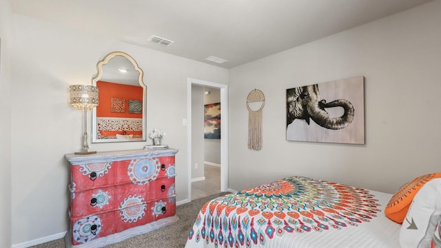 bedroom featuring baseboards, visible vents, and carpet flooring