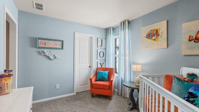 carpeted bedroom featuring visible vents and baseboards