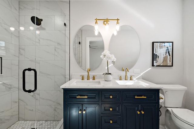 full bath featuring double vanity, a sink, toilet, and a shower stall