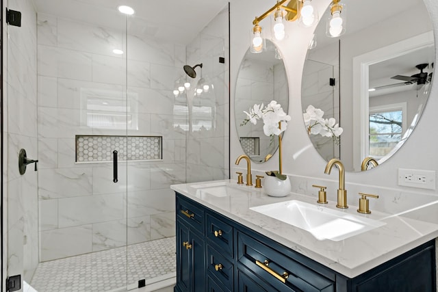 bathroom with a stall shower, ceiling fan, and a sink