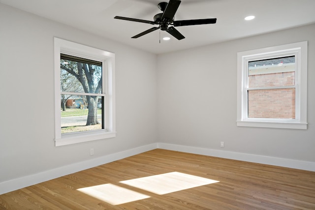 spare room featuring light wood-style flooring, baseboards, and recessed lighting