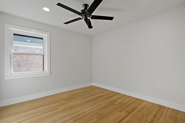 empty room featuring a ceiling fan, recessed lighting, baseboards, and wood finished floors