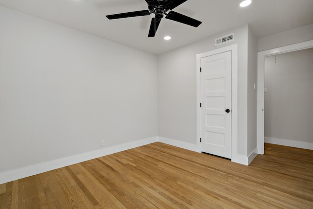 unfurnished room featuring attic access, baseboards, visible vents, light wood-style floors, and recessed lighting