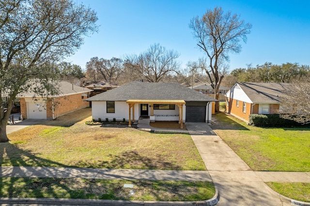 view of front of home featuring concrete driveway, an attached garage, and a front lawn