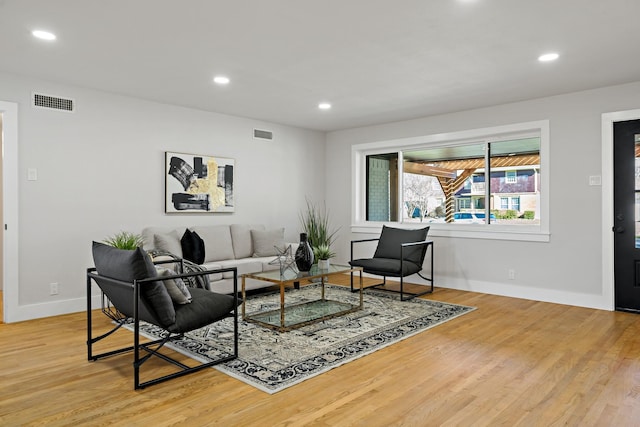 living area with visible vents, wood finished floors, and recessed lighting