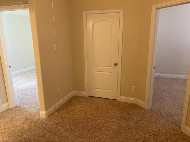 interior space featuring baseboards and carpet floors