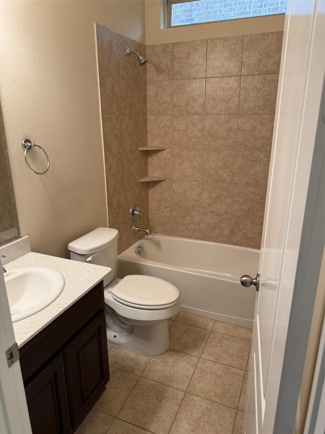 full bath featuring washtub / shower combination, toilet, a textured wall, tile patterned floors, and vanity