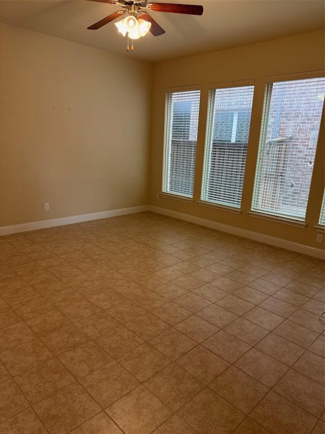 empty room with baseboards and ceiling fan