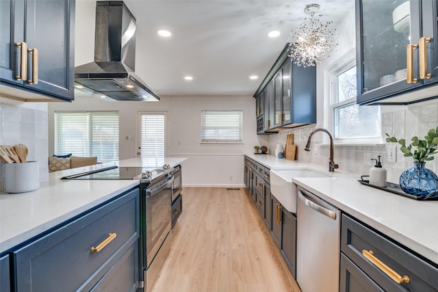13660 Purple Sage Rd, Dallas, TX 75240 - kitchen with extractor fan, stainless steel appliances, a sink, light wood-style floors, and light countertops