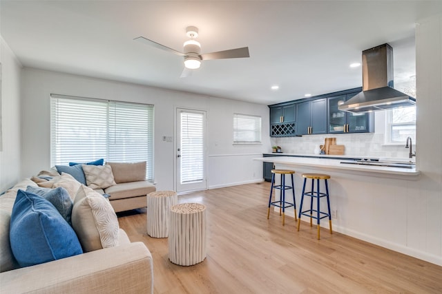 13660 Purple Sage Rd, Dallas, TX 75240 - living area featuring light wood-style floors, plenty of natural light, baseboards, and a ceiling fan