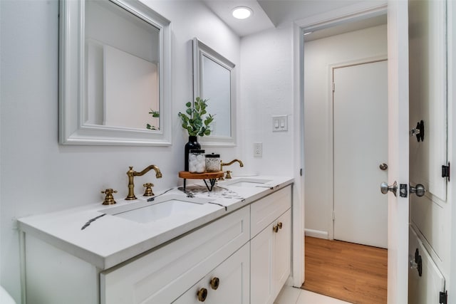 13660 Purple Sage Rd, Dallas, TX 75240 - bathroom with double vanity, a sink, and wood finished floors