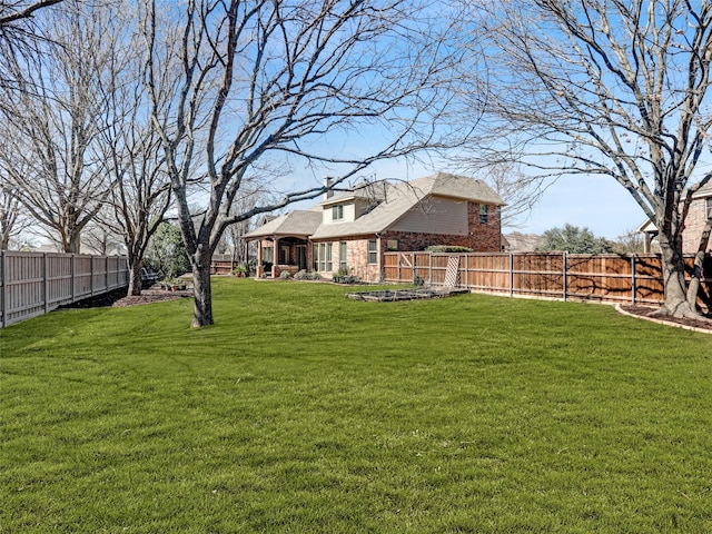 view of yard with a fenced backyard