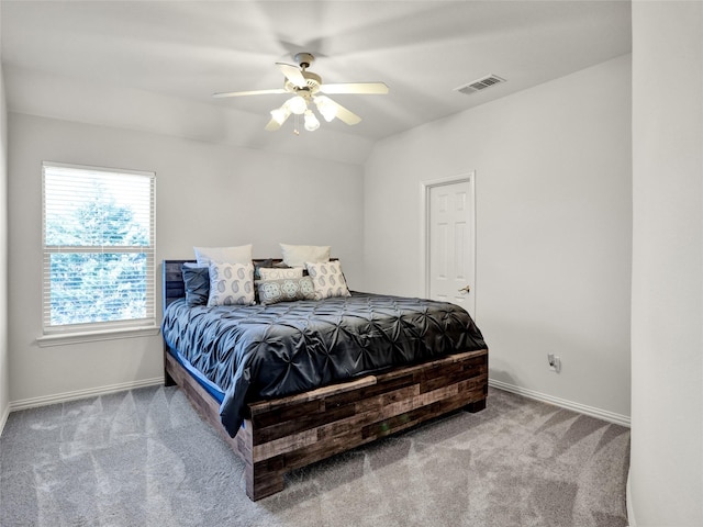 carpeted bedroom featuring visible vents, baseboards, lofted ceiling, and ceiling fan