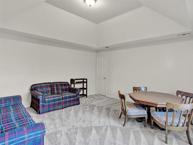 dining area featuring baseboards, a tray ceiling, and carpet floors