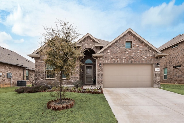 view of front facade with a garage, a front yard, concrete driveway, and brick siding