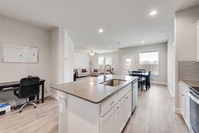 kitchen featuring stainless steel appliances, light wood-style floors, a healthy amount of sunlight, and a sink