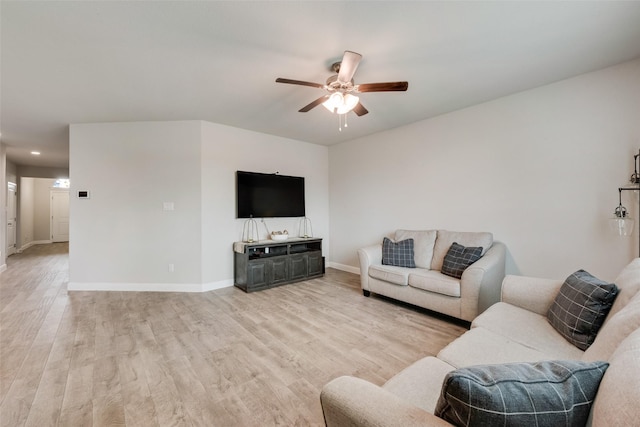 living room featuring light wood-style floors, ceiling fan, and baseboards