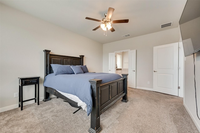 bedroom with baseboards, visible vents, and light colored carpet